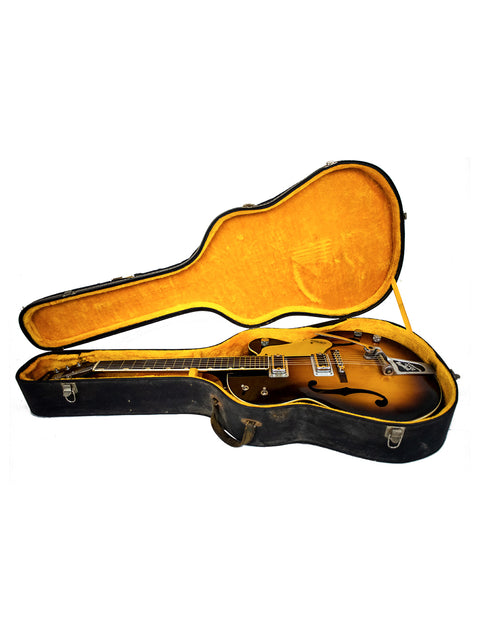Inside a guitar case, a 1964 Vintage Gretsch Double Anniversary 6117 rests, representing classic American craftsmanship.