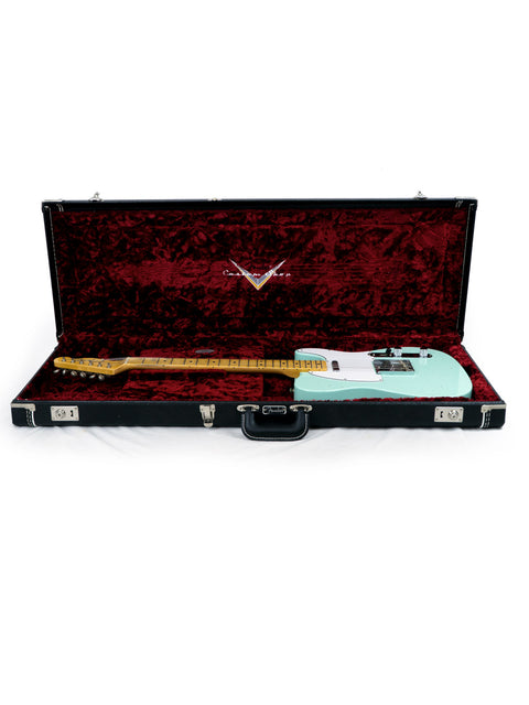 Inside a guitar case, a green Fender Custom Shop 60s Journeyman Telecaster from 2018 is prominently displayed.