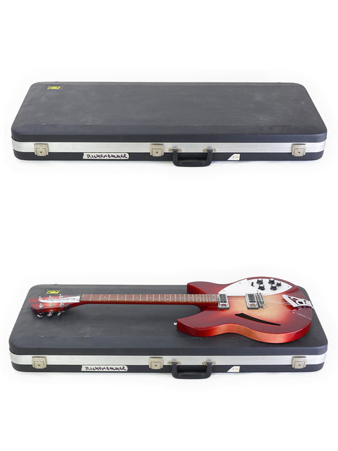 Inside a guitar case, a striking red Rickenbacker 330 Fireglo from 2006 is displayed, ready for performance.