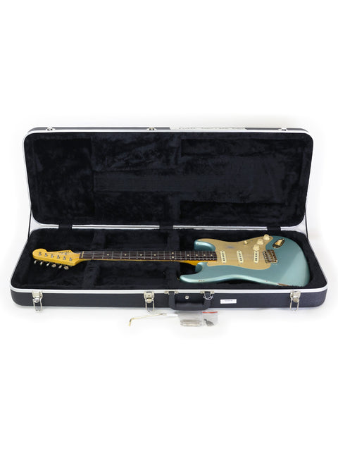 Inside a guitar case, a vibrant green Fender Custom Shop Ltd Poblano Partscaster from 2020 is displayed.