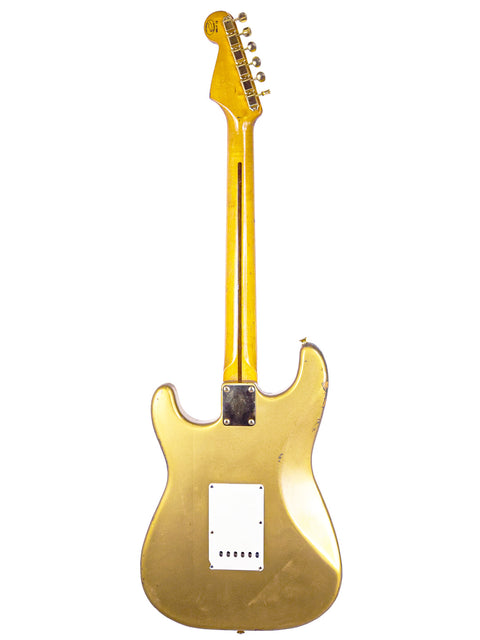 Limited edition 1988 gold Fender Stratocaster guitar featuring a white pickguard, model HLE ’57, highlighting its unique craftsmanship.