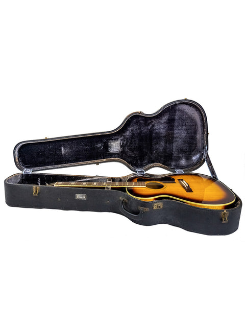 Open guitar case featuring a striking orange 1962 Guild F-40 Valencia, emphasizing its vintage appeal and quality.