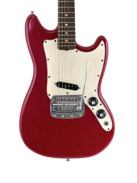 Red 1976 Fender Bronco electric guitar featuring a white pickup, exemplifying vintage American guitar artistry.