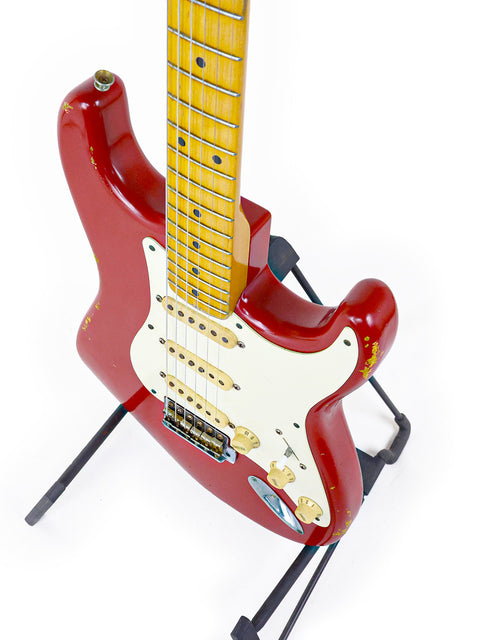 Red Fender Custom Shop ’56 Stratocaster Relic guitar on a stand against a clean white background.