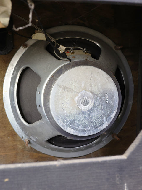Vintage 1968 VOX AC50 MKII speaker showing a broken speaker and wire, emphasizing its historical wear and tear.