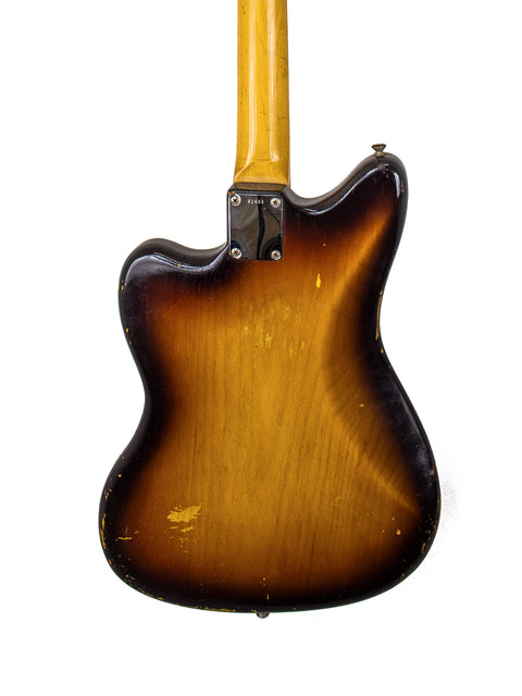 Vintage Fender Jazzmaster guitar with a brown body and black pickguard, showcasing classic 1960s American craftsmanship.