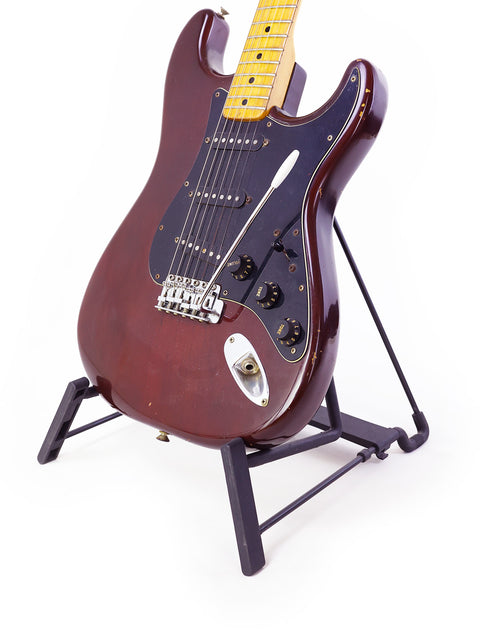 Vintage Fender Stratocaster from 1979 on a stand, featuring a stark white background.