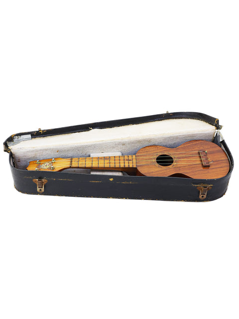 Vintage Kaai Style 2 Koa Ukulele from Hawaii c.1918 displayed in its case against a white backdrop.