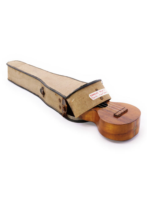 Vintage Kumalae Style 2 ukulele, c. 1913, displayed in its case on a bright white background.