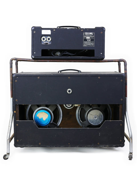 Vintage VOX AC50 MKII speakers and a suitcase on wheels, representing a nostalgic music journey from the UK, 1968.
