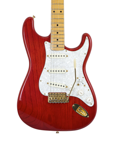 striking red electric guitar, the Fender MIJ '57 Style Stratocaster from 1992, adorned with a contrasting white pickguard.