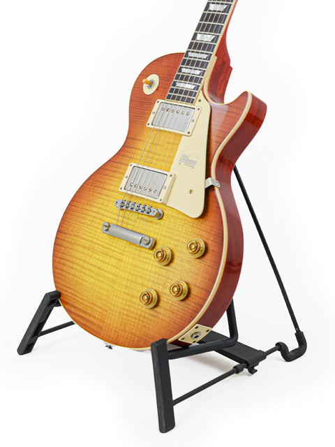 stunning Gibson Custom Shop '59 Les Paul Standard R/I guitar displayed on a stand with a bright white backdrop.