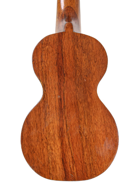 A 1920s Kumalae ukulele with a rich wooden body and neck, reflecting the traditional Hawaiian design and musical heritage.