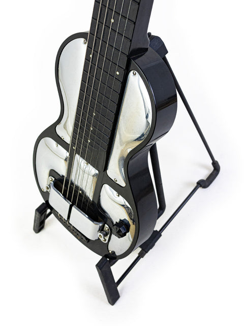 1930s Rickenbacher Electro B-6 Lap Steel guitar resting on a metal stand, set against a bright white background.