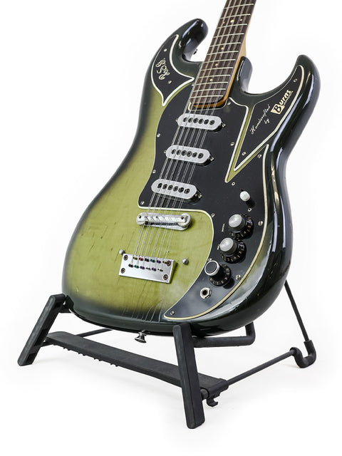 1964 Burns Double Six 12-string guitar elegantly resting on a stand, highlighted by a black background.