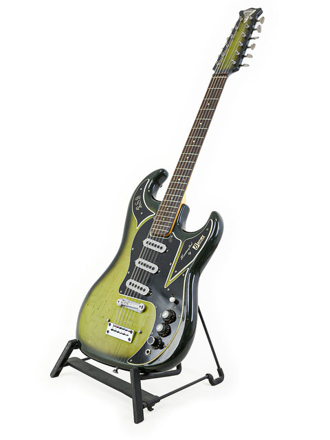 1964 Burns Double Six 12-string guitar resting on a stand, highlighted by a black background.