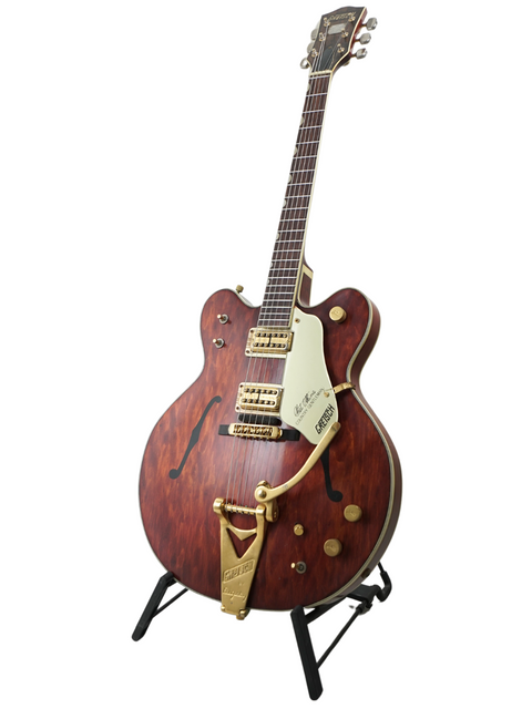 1967 Gretsch 6122 Chet Atkins guitar with a wooden body and gold headstock, highlighting its timeless vintage appeal.