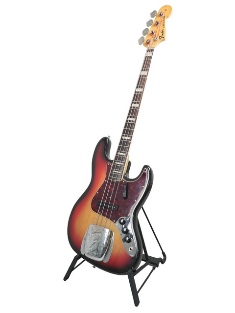 1972 Fender Jazz Bass guitar displayed on a stand, featuring its timeless design and beautiful craftsmanship.