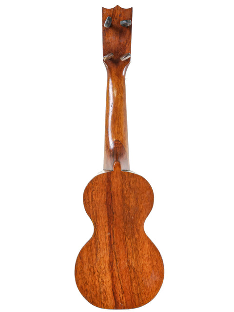 A 1920s Kumalae ukulele with a rich wooden body and neck, reflecting the traditional Hawaiian design and musical heritage.