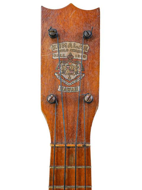 A 1920s Kumalae ukulele with a wooden head and neck, highlighting its classic design and rich Hawaiian musical heritage.