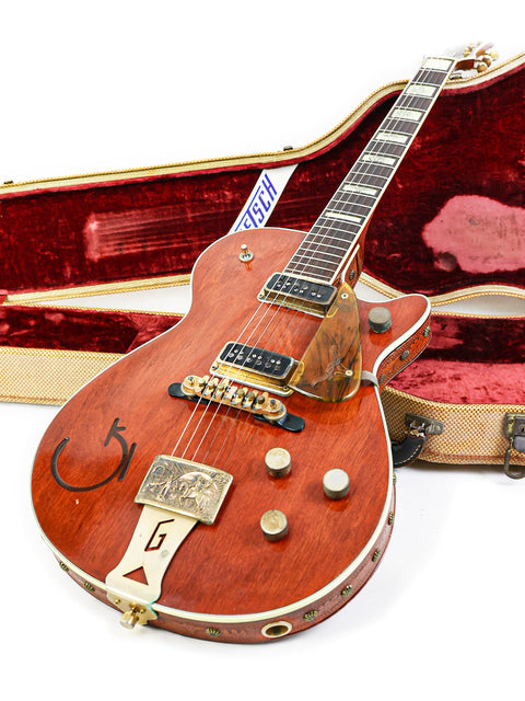 A 1955 Gretsch 6130 Roundup guitar resting in its case, highlighting its vintage craftsmanship.
