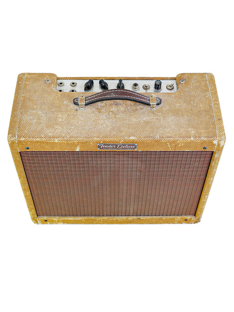 A 1959 Fender Tweed Deluxe 5E3 amp, elegantly wrapped in a brown and white cover, radiating vintage vibes.
