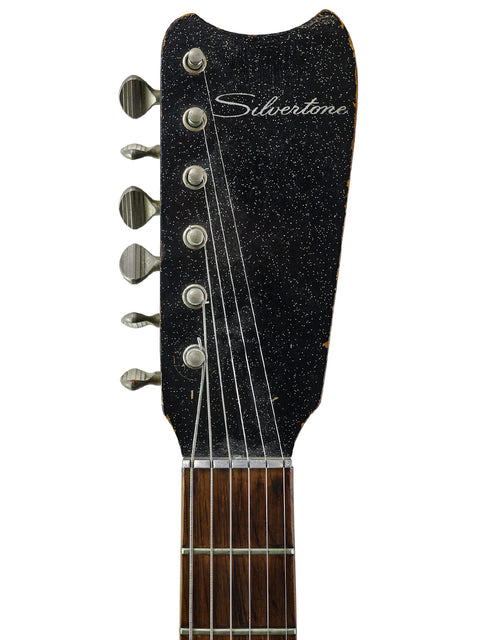 A 1961 Gibson Les Paul Standard displayed with a mid-1960s Harmony Silvertone 1448 featuring 'Amp-in-Case'.