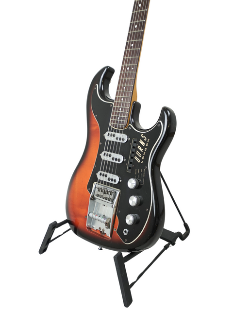 A 1964 Burns Split Sound guitar resting on a stand, highlighted by a deep black background.