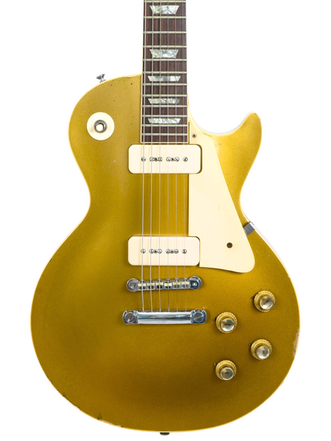 A 1968 Gibson Les Paul Standard Goldtop guitar, showcasing a gold body and a contrasting white pickguard.