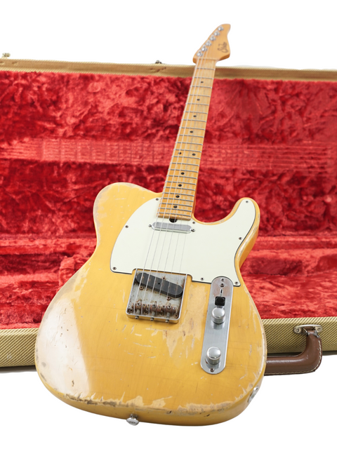 A Fender Telecaster nestled in a case, wrapped in rich red velvet, highlighting its Suhr Classic T Antique Trans Butterscotch design.