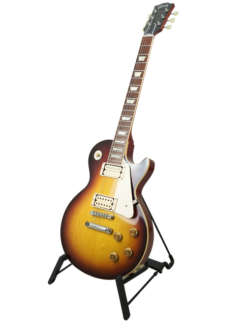A Gibson Custom LPR-8 '58 Les Paul Standard R/I guitar resting on a stand, highlighting its classic features and finish.