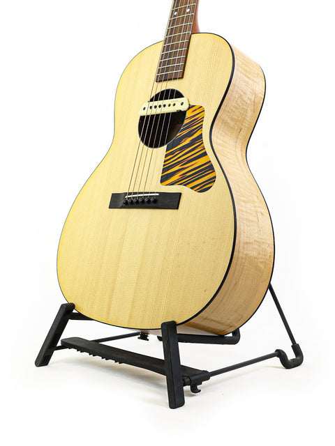 A beautiful wooden guitar, the Waterloo WL-14 X Scissortail, elegantly positioned on a stand.