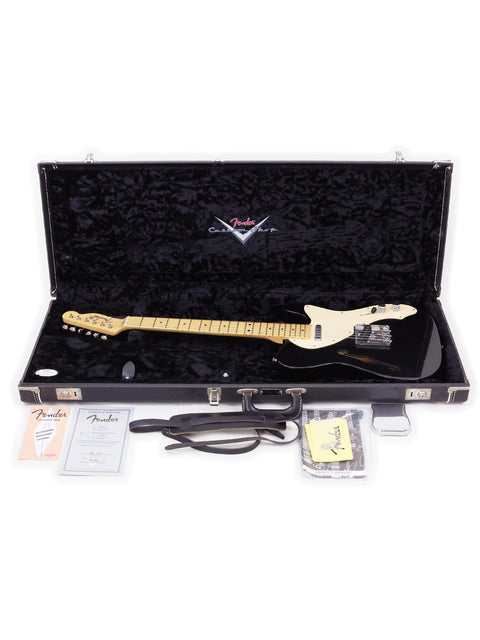 A black Fender Custom Shop Telecaster Thinline guitar in its case, with a guitar pick placed next to it.