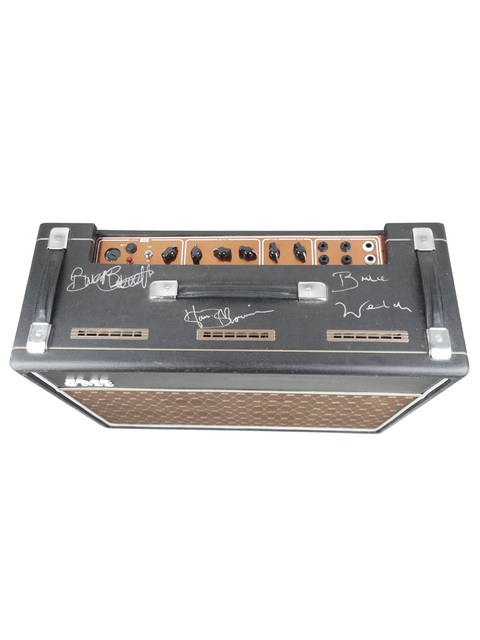 A black and brown amplifier with a guitar placed on it, representing the JMI-30 Shadows Anniversary Tour signed model from 2009 in the UK.