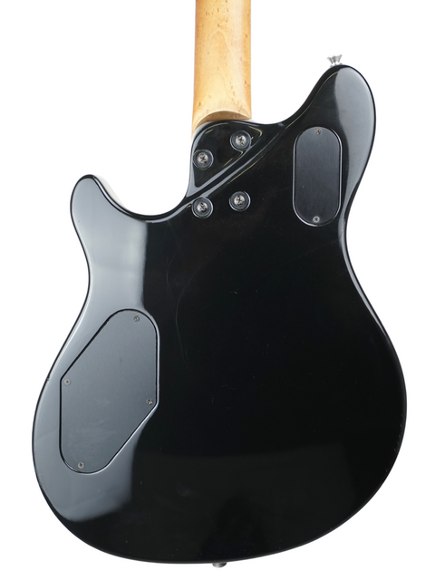 A black electric guitar with a wooden body, showcasing the Peavey EVH Wolfgang Standard Hardtail from 2000, USA-made.