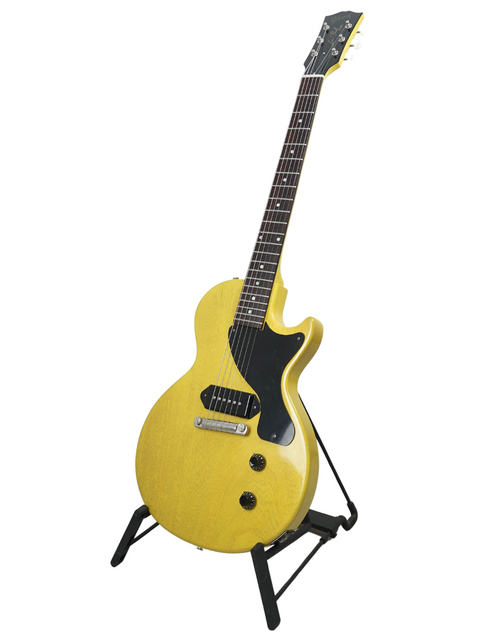 A bright yellow electric guitar, the Gibson Custom Les Paul Jr. TV Yellow, proudly positioned on a stand.