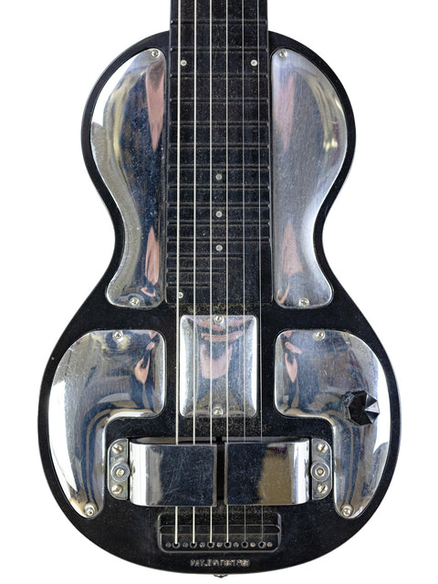 A classic 1930s Rickenbacher Electro B-6 Lap Steel guitar featuring a black metal body and a striking silver headstock.