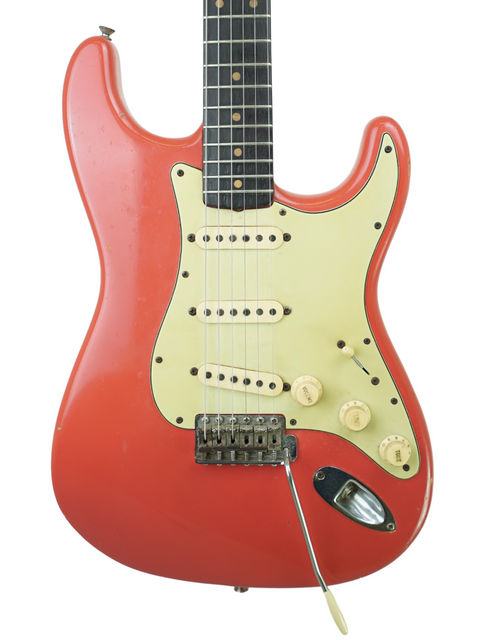 A classic 1963 Fender Stratocaster electric guitar in Fiesta Red, equipped with a white pickup, previously owned by Phil Emmanuel.