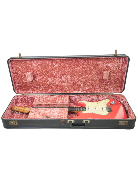 A classic 1963 Fender Stratocaster electric guitar in Fiesta Red, featuring a rich history linked to Phil Emmanuel.