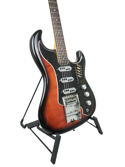  A classic 1964 Burns Split Sound guitar displayed on a stand, contrasting beautifully with a black backdrop.