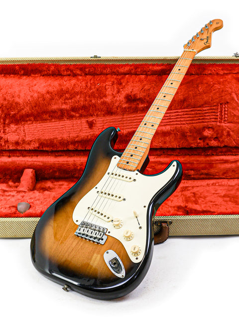 A classic 1982 Fender AVRI '57 Stratocaster guitar resting in a vibrant red case, ready for its next performance.
