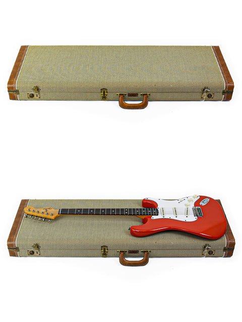 A classic red Fender AVRI ‘62 Stratocaster guitar from 1982, neatly stored in a case with a handle for easy transport.