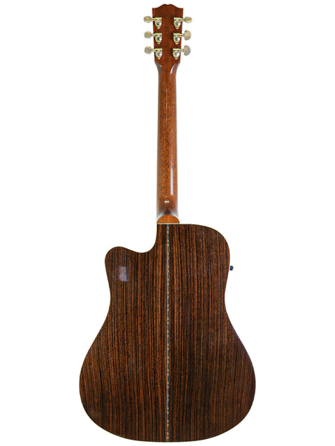 A close-up of the wooden back of a 2014 Gibson Songwriter Studio Deluxe EC acoustic guitar, highlighting its craftsmanship.