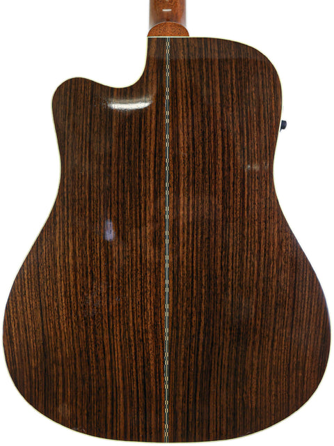 A close-up of the wooden back of a Gibson Songwriter Studio Deluxe EC acoustic guitar, highlighting its craftsmanship.