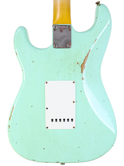 A green Fender Yuriy Shishkov Master Built ‘59 Stratocaster Relic guitar featuring a white pick guard, crafted in the USA, 2020.
