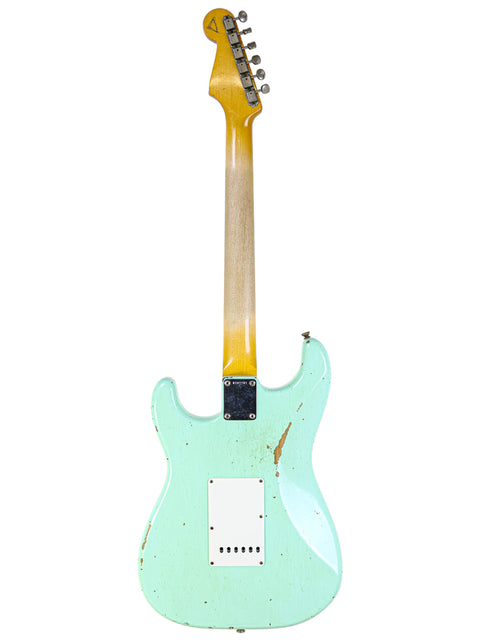A green guitar with a yellow body and neck, showcasing the Fender Yuriy Shishkov Master Built ‘59 Stratocaster Relic from 2020.