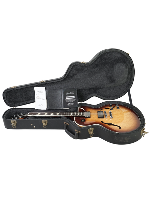 A guitar case containing a 2009 Gibson Custom ES-137 Classic, highlighting its premium quality and iconic shape.