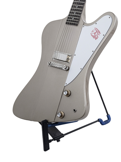 A metallic grey electric guitar with a white pickguard and a red logo, mounted on a black stand.