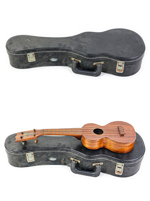 A pair of 1920s Kumalae ukuleles nestled in a case, showcased on a bright white background.
