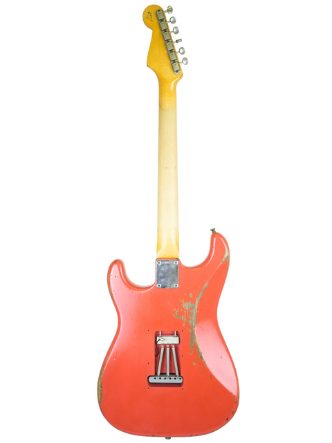 A red Fender Kyle McMillin Masterbuilt 1960 Stratocaster Relic guitar with a gold pickguard, showcasing its vintage design.